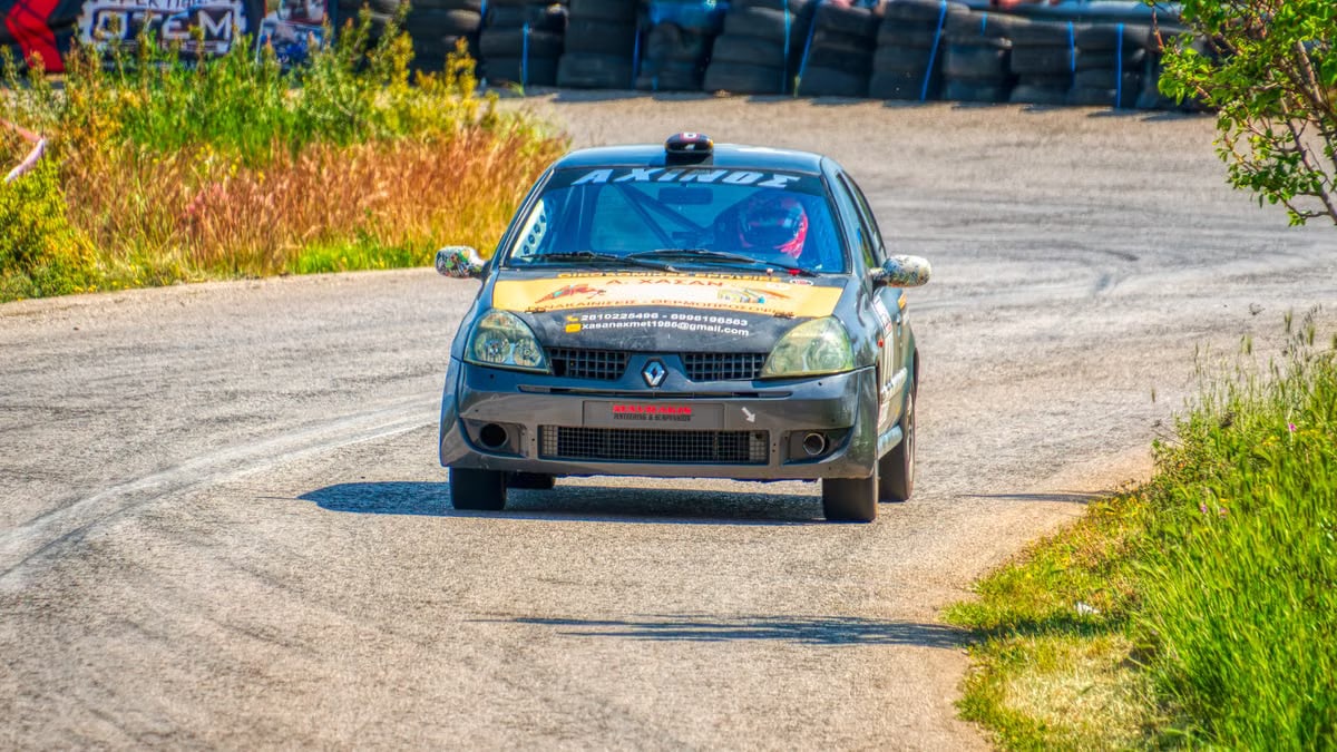 Thrilling car race along a winding track in Ritsona, Greece, showcasing speed and excitement.